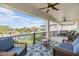 Inviting balcony with comfortable seating, a ceiling fan, and panoramic waterfront vistas at 16025 Redington Dr, Redington Beach, FL 33708
