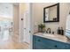 Modern bathroom boasts granite counters and a stylish blue vanity with brushed nickel fixtures at 16025 Redington Dr, Redington Beach, FL 33708