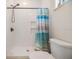 Clean bathroom with white tiled shower and toilet; bright natural light and minimalist decor at 16025 Redington Dr, Redington Beach, FL 33708