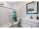 Bright bathroom with tiled shower, white vanity with sink and toilet at 16025 Redington Dr, Redington Beach, FL 33708