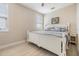 Bedroom with white wainscoting and a matching white bed frame and side tables at 16025 Redington Dr, Redington Beach, FL 33708