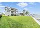 Spacious home with a large lawn and a private dock, ideal for enjoying waterfront living and outdoor activities at 16025 Redington Dr, Redington Beach, FL 33708