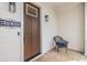 Charming front entrance featuring a cozy chair, stylish door hardware, and elegant house number display at 16025 Redington Dr, Redington Beach, FL 33708