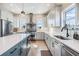 Beautiful kitchen with stainless steel appliances and white cabinets with an island at 16025 Redington Dr, Redington Beach, FL 33708