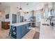 Bright, spacious kitchen with a large island, stainless steel appliances, and custom backsplash detailing at 16025 Redington Dr, Redington Beach, FL 33708