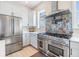 Bright kitchen with stainless steel appliances and decorative backsplash detail at 16025 Redington Dr, Redington Beach, FL 33708
