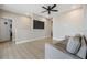 Bright living room with gray sofa, light wood floors, tv mounted on the wall at 16025 Redington Dr, Redington Beach, FL 33708