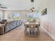 Open-concept living space with a dining table and a comfortable living room area at 16025 Redington Dr, Redington Beach, FL 33708
