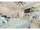 Bright main bedroom features a ceiling fan, television, a closet, and an ensuite bathroom at 16025 Redington Dr, Redington Beach, FL 33708