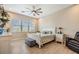 Bright main bedroom with a ceiling fan, luxury vinyl plank flooring, and large windows at 16025 Redington Dr, Redington Beach, FL 33708