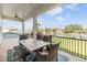 Covered patio features a table with seating and serene waterfront views at 16025 Redington Dr, Redington Beach, FL 33708