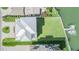 Aerial view showcases the home's metal roof, boat dock, and manicured backyard at 16025 Redington Dr, Redington Beach, FL 33708