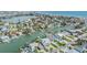 Aerial shot displaying waterfront homes, private docks, and community layout in a coastal neighborhood at 16025 Redington Dr, Redington Beach, FL 33708