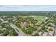 Aerial view of the community with baseball field, pond and trees at 1693 Fry Ct, Dunedin, FL 34698
