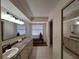 Bright bathroom with a large mirror, lengthy vanity, and tiled floors for a clean, modern aesthetic at 1693 Fry Ct, Dunedin, FL 34698
