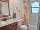 Bathroom featuring a sink and shower with a patterned curtain at 1693 Fry Ct, Dunedin, FL 34698