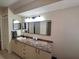 Neat bathroom vanity area featuring a sink, granite-style countertop, and ample storage cabinets at 1693 Fry Ct, Dunedin, FL 34698
