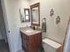 Bathroom featuring granite countertop, wood cabinets, updated faucet and toilet at 1693 Fry Ct, Dunedin, FL 34698