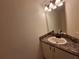 Half-bathroom with vanity sink, countertop, and neutral finishes at 1693 Fry Ct, Dunedin, FL 34698