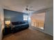 Bedroom features a ceiling fan, blue accent wall, and natural light at 1693 Fry Ct, Dunedin, FL 34698
