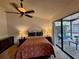 Bedroom featuring comfortable furniture, warm lighting, and access to outdoor space at 1693 Fry Ct, Dunedin, FL 34698