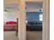 View through doorway into two separate bedrooms, each with unique color schemes and furnishings at 1693 Fry Ct, Dunedin, FL 34698