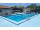 Beautiful community pool with lounge seating, perfect for relaxation and recreation at 1693 Fry Ct, Dunedin, FL 34698