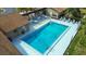Aerial view of community pool with lounge seating and beautiful landscaping at 1693 Fry Ct, Dunedin, FL 34698