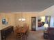 Dining room with classic chandelier, view into the bedroom, and neutral tones at 1693 Fry Ct, Dunedin, FL 34698