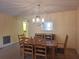 Dining room with a traditional table set and a view into the living spaces at 1693 Fry Ct, Dunedin, FL 34698