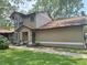 Exterior view of house featuring manicured lawn, sidewalk, and a pleasing color scheme at 1693 Fry Ct, Dunedin, FL 34698