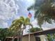 American flag waving at Braemoor Village with palm trees at 1693 Fry Ct, Dunedin, FL 34698