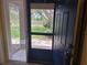 The front door allows lots of light and showcases the greenery of the front yard at 1693 Fry Ct, Dunedin, FL 34698