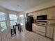 Cozy kitchen with black appliances, tile floors, and breakfast nook at 1693 Fry Ct, Dunedin, FL 34698