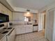 Bright kitchen featuring white appliances and ample storage space at 1693 Fry Ct, Dunedin, FL 34698