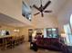 Living room showcasing high ceilings, natural light, and access to the bedroom and outdoor patio at 1693 Fry Ct, Dunedin, FL 34698