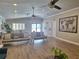 Bright living room with modern furniture, ceiling fans, and stylish decor at 1693 Fry Ct, Dunedin, FL 34698