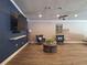 Cozy living room featuring stylish furniture, a ceiling fan, and a sleek entertainment setup at 1693 Fry Ct, Dunedin, FL 34698
