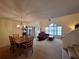 Open-concept living room and dining area with natural light and neutral colors at 1693 Fry Ct, Dunedin, FL 34698
