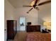 Cozy bedroom with a ceiling fan, dresser, and a view into an adjacent tiled room at 1693 Fry Ct, Dunedin, FL 34698