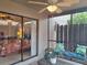 Covered patio with views into a bedroom and a serene outdoor sitting area at 1693 Fry Ct, Dunedin, FL 34698
