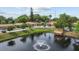 Scenic community pond featuring a fountain and wooden dock for relaxation and enjoyment at 1693 Fry Ct, Dunedin, FL 34698