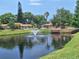 Community pond with water fountain provides a peaceful view at 1693 Fry Ct, Dunedin, FL 34698