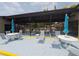 Outdoor pool area with comfortable lounge chairs and tables under a shaded pavilion at 1693 Fry Ct, Dunedin, FL 34698