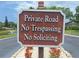 A sign reading Private Road, No Trespassing, No Soliciting sits in front of a pond at 1693 Fry Ct, Dunedin, FL 34698