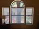 Bright window with tree view offers natural light and a connection to the outdoors at 1693 Fry Ct, Dunedin, FL 34698