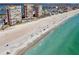 Wide sandy beach aerial view with ocean waves, condominium buildings, pool, and blue skies in this coastal community at 17920 Gulf Blvd # 1302, Redington Shores, FL 33708