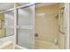 Bathroom features a glass enclosed shower/tub and tiled walls at 17920 Gulf Blvd # 1302, Redington Shores, FL 33708