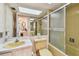 Bright bathroom with a glass enclosed shower/tub and a large skylight at 17920 Gulf Blvd # 1302, Redington Shores, FL 33708