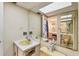 View of the bathroom sink and large mirror with bright lighting at 17920 Gulf Blvd # 1302, Redington Shores, FL 33708